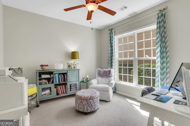 sitting room with visible vents, carpet flooring, baseboards, and a ceiling fan