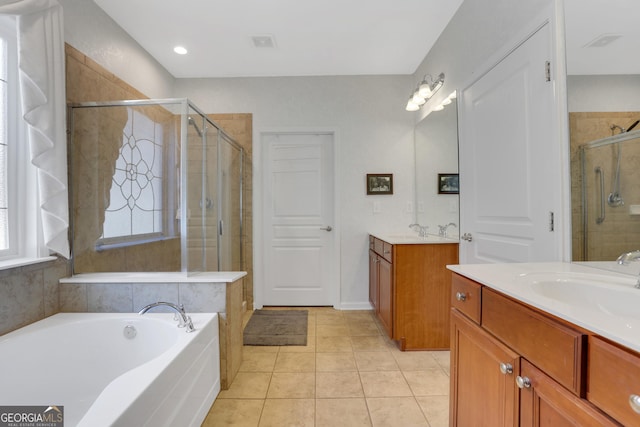full bath with two vanities, a sink, tile patterned flooring, and a stall shower