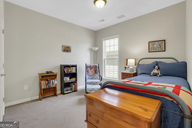 bedroom featuring baseboards, visible vents, and light colored carpet