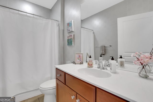 bathroom featuring vanity, tile patterned flooring, a shower with curtain, and toilet