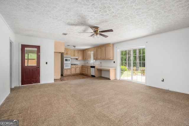 kitchen with ceiling fan, white appliances, baseboards, light countertops, and carpet floors
