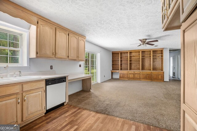 kitchen featuring a textured ceiling, ceiling fan, white dishwasher, and light countertops