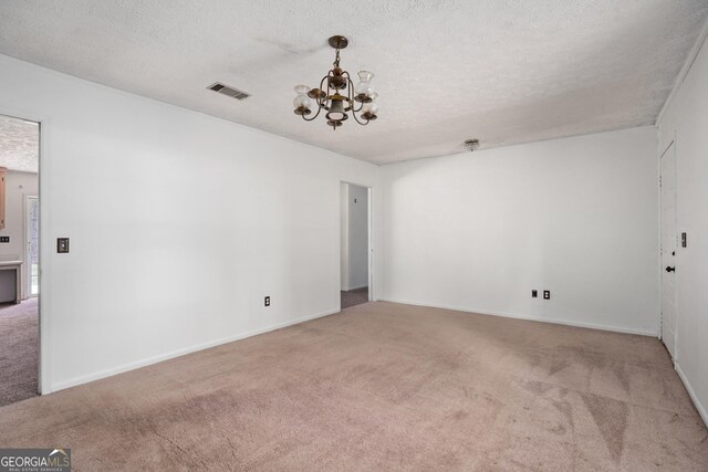 unfurnished room with baseboards, a textured ceiling, and carpet