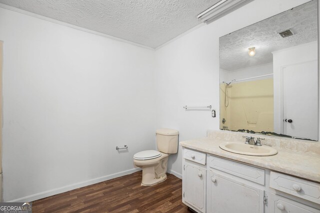 unfurnished bedroom with a textured ceiling, visible vents, carpet floors, and baseboards