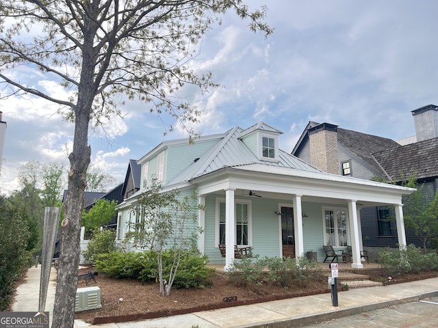 view of front of house featuring a porch, metal roof, and a ceiling fan
