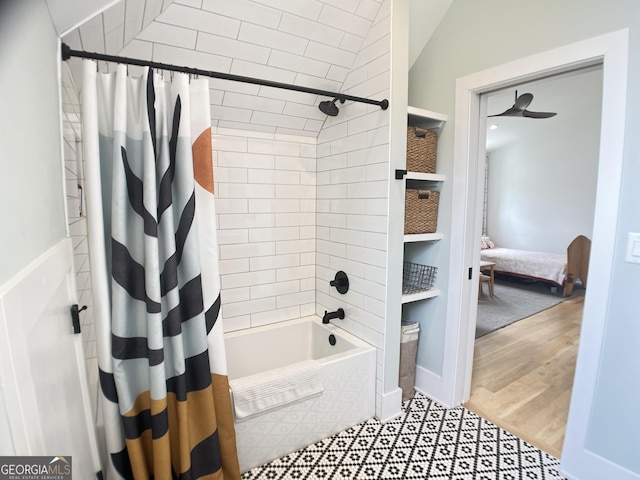 ensuite bathroom featuring shower / bath combination with curtain and connected bathroom