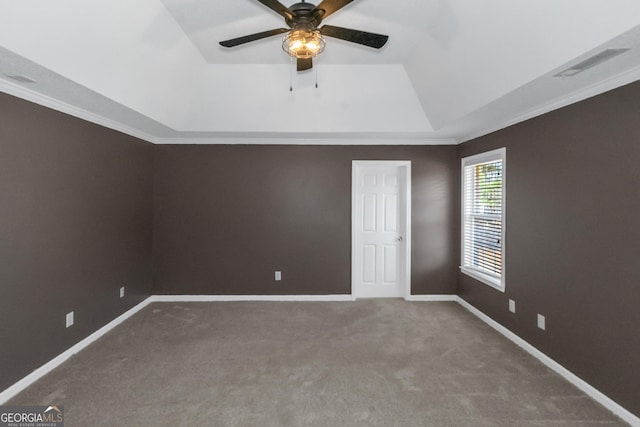 unfurnished room with visible vents, a ceiling fan, carpet flooring, and a tray ceiling