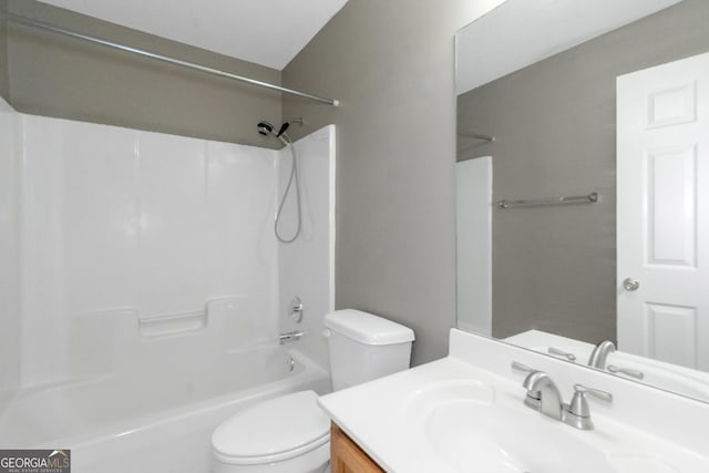 bathroom featuring washtub / shower combination, vanity, and toilet