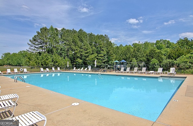 53 Gordon Manor Ct, Senoia, GA 30276 - community pool with a patio area and view of wooded area