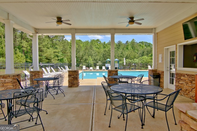 53 Gordon Manor Ct, Senoia, GA 30276 - view of patio featuring ceiling fan, a community pool, and outdoor dining space