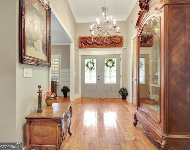 53 Gordon Manor Ct, Senoia, GA 30276 - entryway with light wood finished floors, a chandelier, and ornamental molding