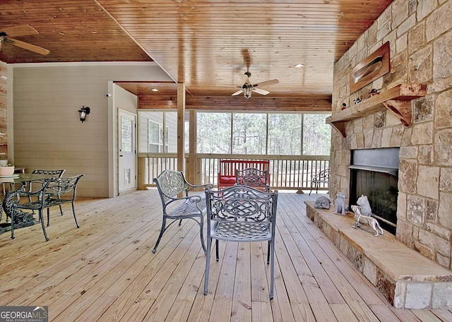53 Gordon Manor Ct, Senoia, GA 30276 - wooden deck with ceiling fan, outdoor dining area, and a stone fireplace