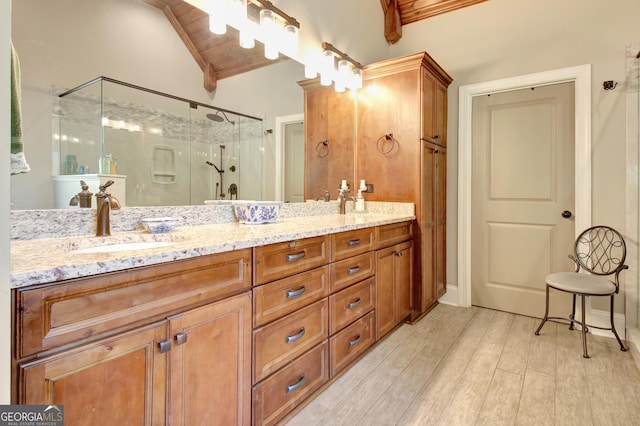 53 Gordon Manor Ct, Senoia, GA 30276 - full bath featuring a shower stall, double vanity, wood finished floors, and vaulted ceiling
