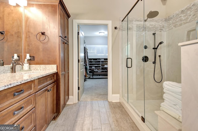 53 Gordon Manor Ct, Senoia, GA 30276 - bathroom featuring a shower stall, vanity, and wood finished floors