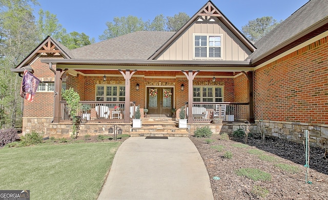 53 Gordon Manor Ct, Senoia, GA 30276 - property entrance featuring board and batten siding, a porch, brick siding, and french doors