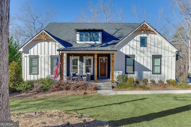 6014 Warpath Rd, Flowery Branch, GA 30542 - view of front of home featuring board and batten siding, covered porch, a standing seam roof, a front lawn, and roof with shingles