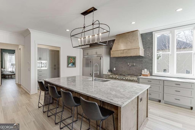 6014 Warpath Rd, Flowery Branch, GA 30542 - kitchen with premium range hood, gray cabinets, built in appliances, a sink, and decorative backsplash