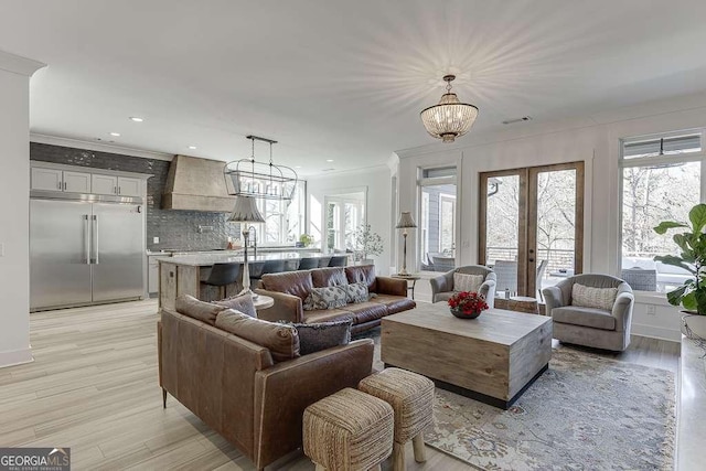 6014 Warpath Rd, Flowery Branch, GA 30542 - living room featuring light wood-type flooring, a chandelier, ornamental molding, and recessed lighting