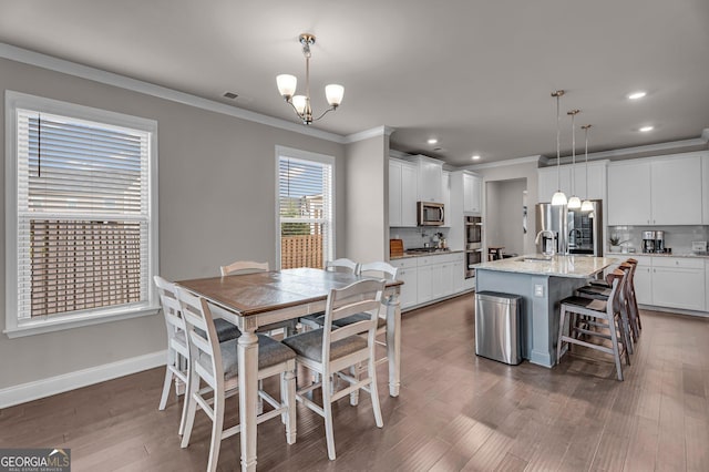 dining room with baseboards, visible vents, an inviting chandelier, recessed lighting, and ornamental molding