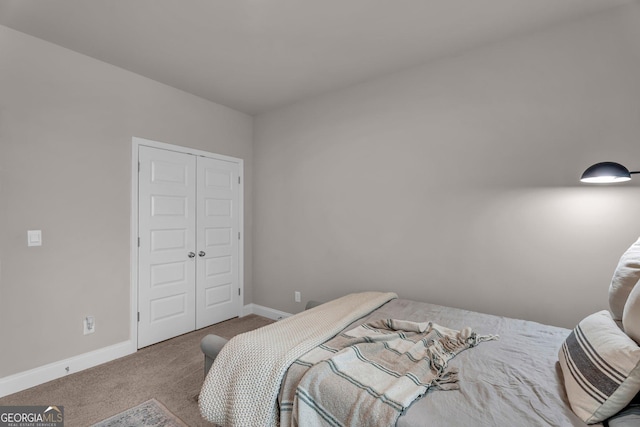 bedroom with carpet floors, a closet, and baseboards
