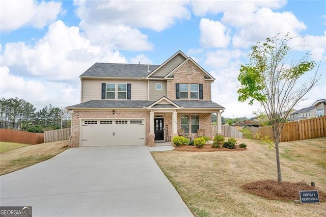 craftsman house featuring fence, an attached garage, driveway, and a front yard