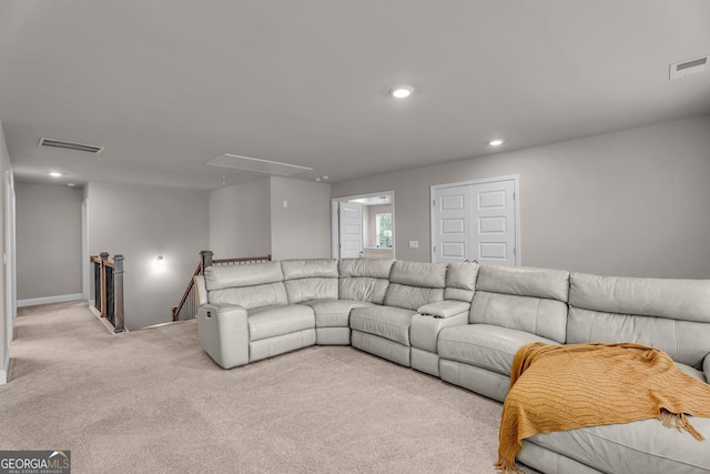 living area featuring attic access, visible vents, recessed lighting, and carpet flooring
