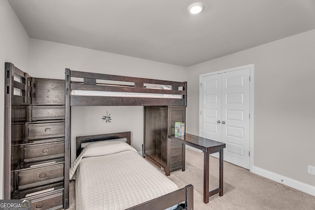 bedroom featuring baseboards and light carpet
