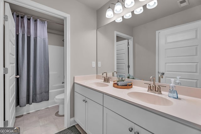 full bathroom with double vanity, visible vents, toilet, and a sink