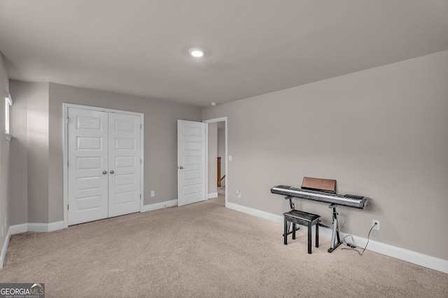 interior space featuring carpet floors and baseboards