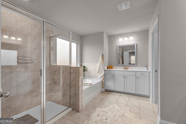 bathroom with a garden tub, tile patterned flooring, a stall shower, and vanity