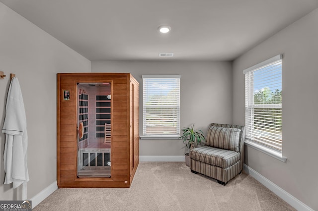 sitting room featuring baseboards, visible vents, and carpet floors