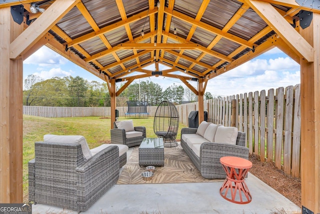 view of patio / terrace with a fenced backyard, an outdoor hangout area, and a trampoline