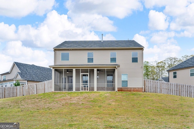 rear view of property with a lawn, a sunroom, a fenced backyard, and ceiling fan