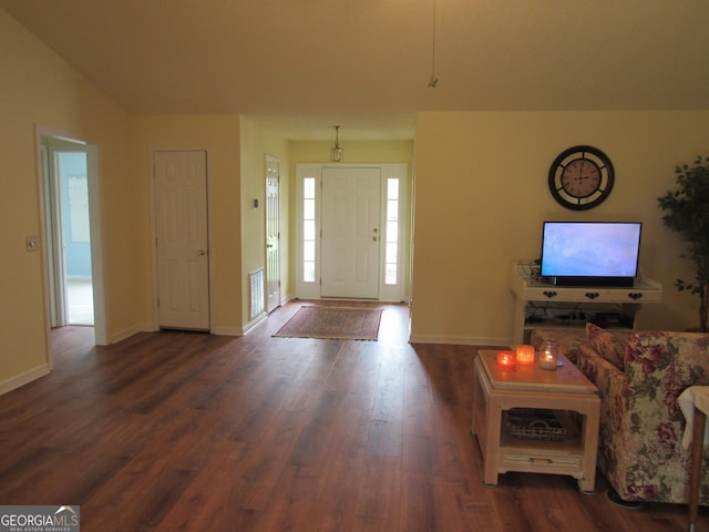 entrance foyer featuring dark wood finished floors and baseboards