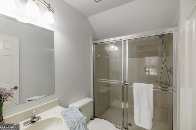 full bathroom featuring toilet, a stall shower, vaulted ceiling, and vanity