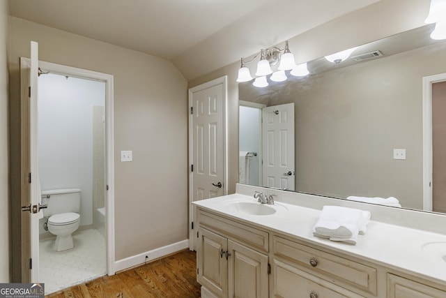 full bathroom featuring vanity, a tub to relax in, toilet, visible vents, and wood finished floors