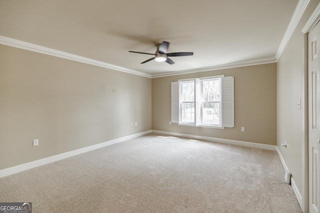 spare room with baseboards, light carpet, a ceiling fan, and crown molding