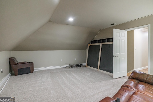 additional living space with carpet, lofted ceiling, and baseboards