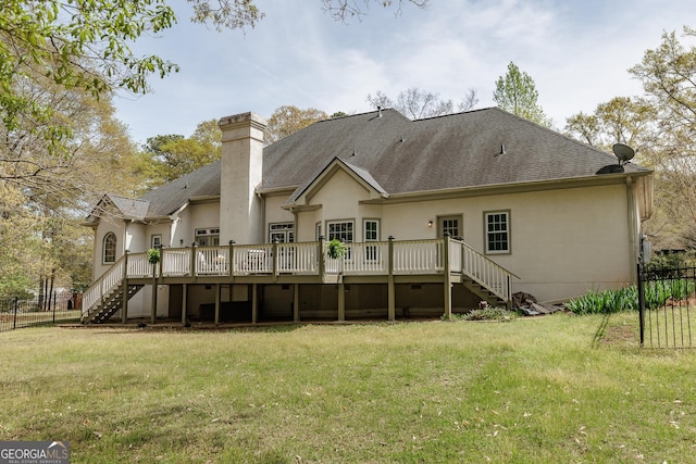back of house featuring stairs, a yard, fence, and a chimney