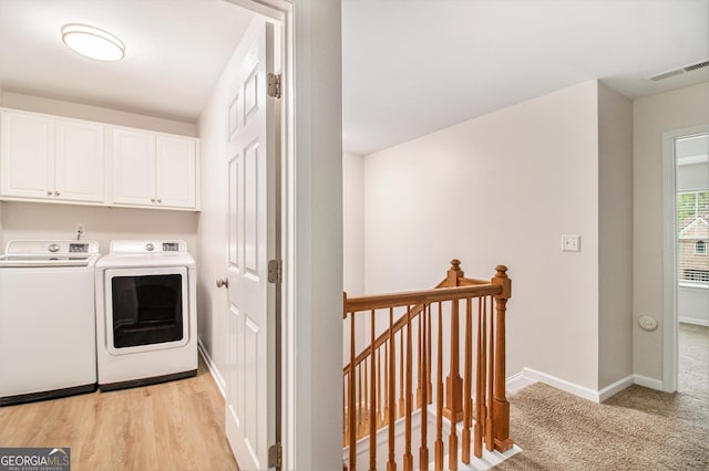 2036 Broadmoor Way, Fairburn, GA 30213 - washroom featuring light carpet, baseboards, visible vents, washer and dryer, and cabinet space