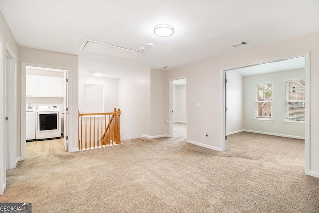 2036 Broadmoor Way, Fairburn, GA 30213 - unfurnished room featuring washer and clothes dryer, attic access, baseboards, visible vents, and light carpet