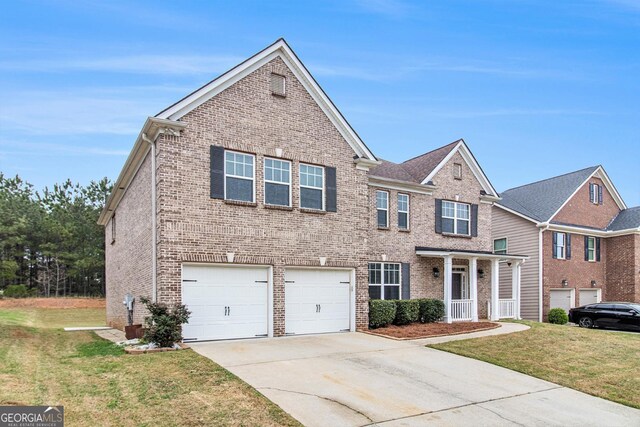2036 Broadmoor Way, Fairburn, GA 30213 - traditional-style house featuring an attached garage, brick siding, concrete driveway, and a front yard