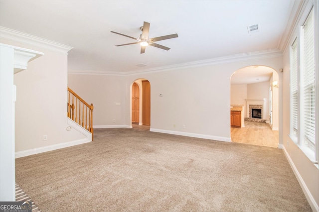 2036 Broadmoor Way, Fairburn, GA 30213 - unfurnished living room featuring stairs, ornamental molding, a ceiling fan, light carpet, and arched walkways