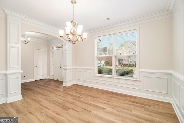 2036 Broadmoor Way, Fairburn, GA 30213 - unfurnished dining area featuring crown molding, an inviting chandelier, arched walkways, visible vents, and light wood-style flooring