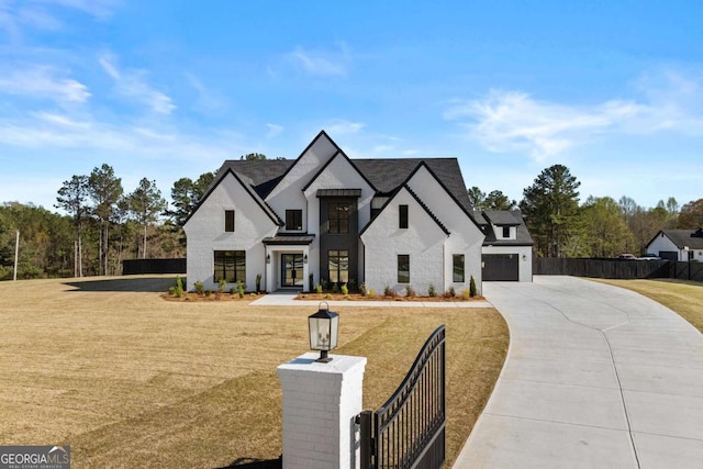 view of front of house with a front lawn, driveway, a fenced front yard, and a garage