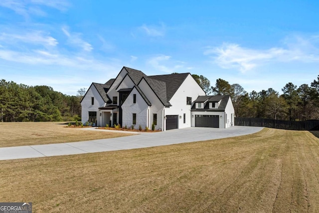 view of front of home with concrete driveway, stucco siding, fence, an attached garage, and a front lawn
