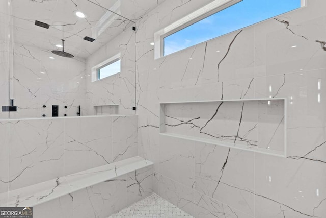 bathroom with a marble finish shower