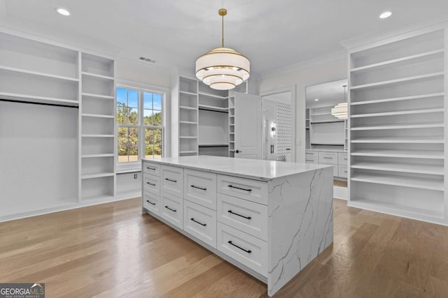 spacious closet with light wood-type flooring and visible vents