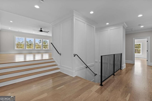 staircase featuring ornamental molding, wood finished floors, recessed lighting, and a ceiling fan
