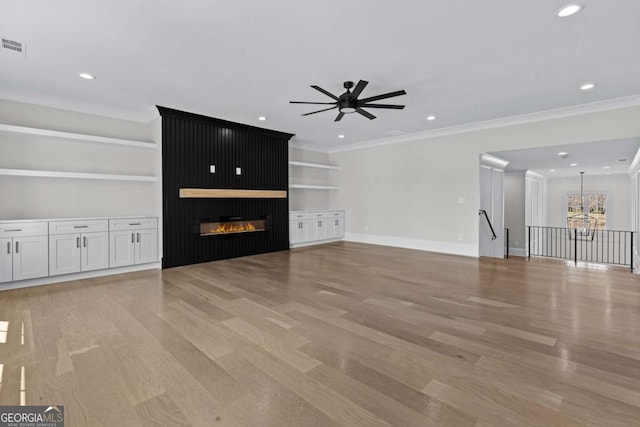 unfurnished living room featuring baseboards, light wood-type flooring, ceiling fan, and built in shelves